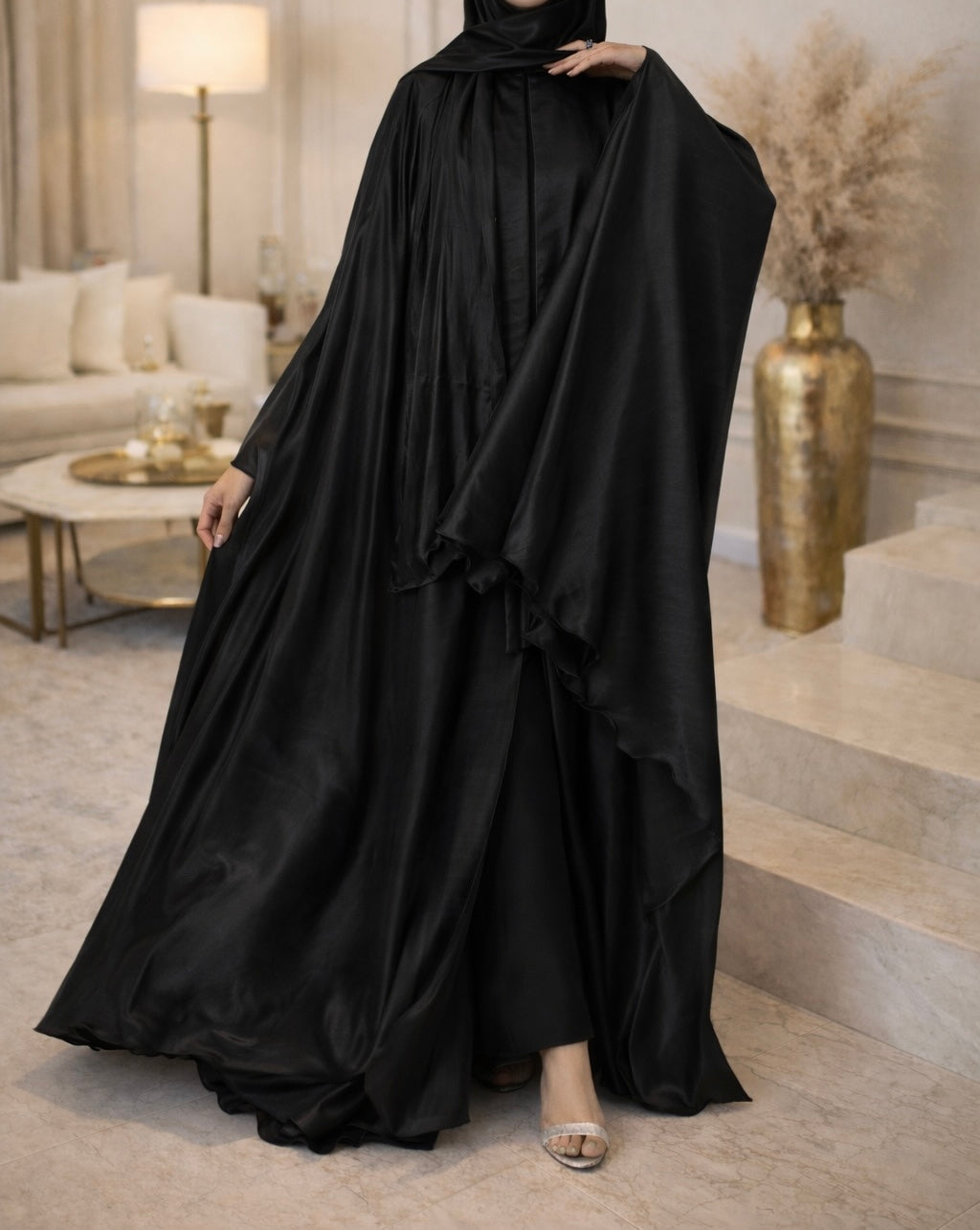 Person wearing a black abaya in a modern living room setting